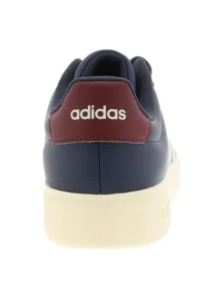 Baskets bleues avec un talon plat pourvu de lacets et de bandes blanches