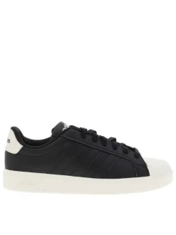 Baskets noires à talon plat avec des lacets et une semelle blanche