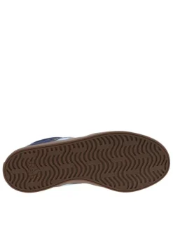 Baskets tennis bleues à talon plat avec un patch de la marque à la languette