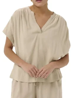 Blouse beige unie pourvue d'un col tunisien et de manches courtes