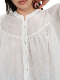 Blouse blanche unie avec une coupe droite et un col rond et des boutons