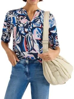 Blouse bleue à motifs avec une coupe droite et un col tunisien