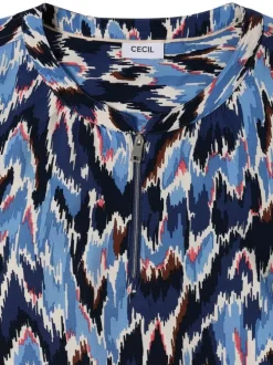 Blouse bleue à motifs pourvue d'une coupe droite et d'un col zippé
