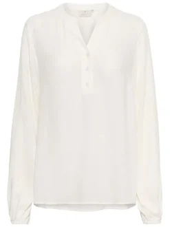 Blouse écrue unie pourvue d'une coupe droite et d'un col tunisien
