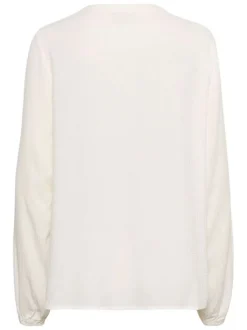 Blouse écrue unie pourvue d'une coupe droite et d'un col tunisien