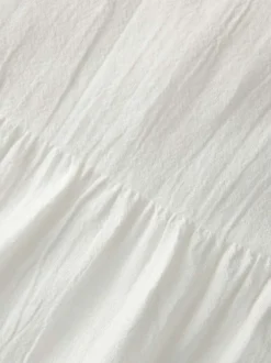 Blouse en coton biologique blanche pourvue d'un col v et de manches longues