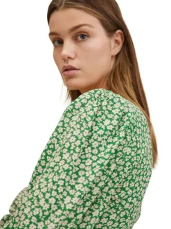 Blouse fluide verte à imprimé floral blanc avec manches longues bouffantes et col v