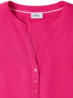 Blouse fuchsia unie pourvue de manches courtes et d'un col tunisien