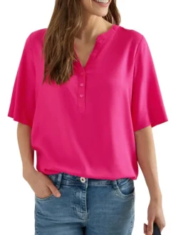 Blouse fuchsia unie pourvue de manches courtes et d'un col tunisien