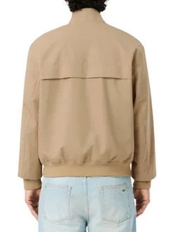 Blouson beige à coupe ajustée pourvu d'un col à boutons pression