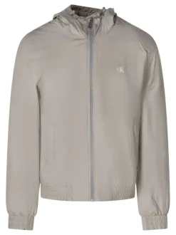 Blouson beige à coupe ajustée pourvu d'un col à capuche avec cordon de serrage
