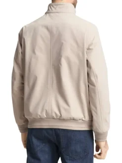 Blouson beige uni avec une coupe droite et deux poches raglan à l’avant