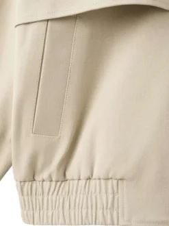 Blouson en coton beige uni pourvu d'une coupe droite et d'un col montant
