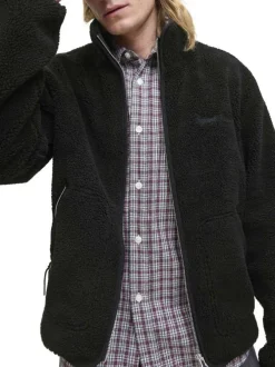 Blouson noir uni en sherpa avec une coupe droite et un col montant
