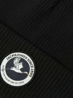 Bonnet en coton noir uni en maille avec un patch sur le revers