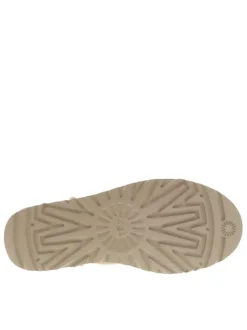 Boots Classic Ultra Mini en cuir beige avec logo cousu à l'arrière