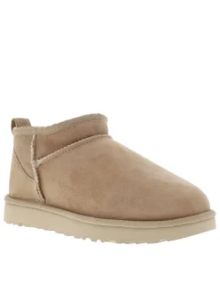 Boots Classic Ultra Mini en cuir beige avec logo cousu à l'arrière