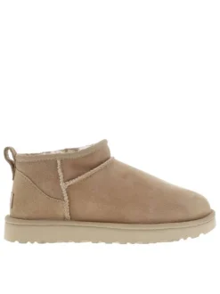 Boots Classic Ultra Mini en cuir beige avec logo cousu à l'arrière