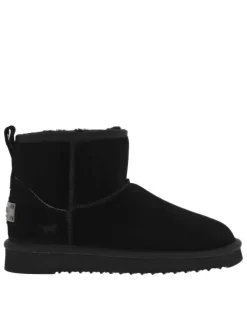 Boots en cuir de vachette noir, fourrées en laine, à semelle plate adhérente