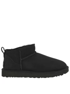 Boots en cuir noires à semelle à talon plat et fourrure à l'intérieur