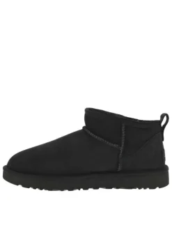 Boots en cuir noires à semelle à talon plat et fourrure à l'intérieur