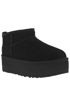 Boots en cuir noires à semelle à talon semi-compensée et fourrure