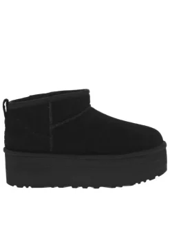 Boots en cuir noires à semelle à talon semi-compensée et fourrure