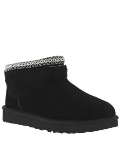 Boots en cuir noires à talon plat avec col brodé, sherpa et intérieur fourré