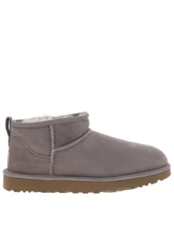 Boots rose à talon plat, fourrées avec tirette arrière et étiquette de la marque