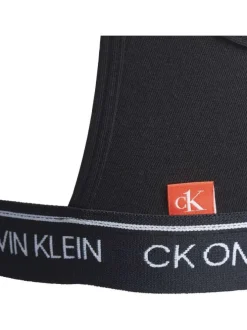 Brassière noire unie avec petite étiquette d'authentification rouge à l'arrière