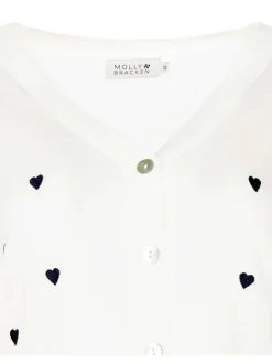 Cardigan blanc avec des cœurs imprimés et une coupe droite à col v