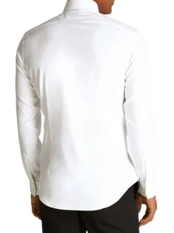 Chemise en coton blanche unie avec une coupe ajustée et les boutons cachés