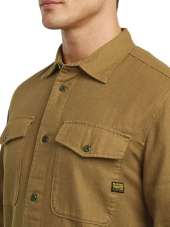 Chemise en coton brun unie avec une coupe droite et des poches