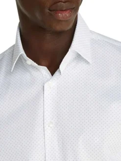 Chemise à manches longues en coton blanche à pois avec une coupe slim