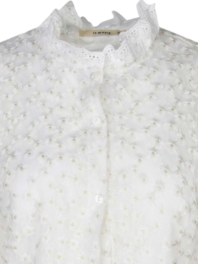 Chemisier beige avec des motifs fleuris à coupe droite et un col montant