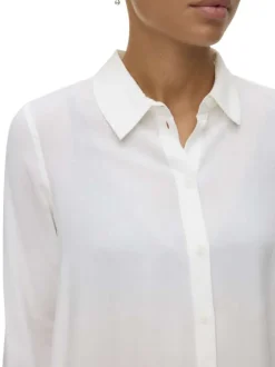 Chemisier blanc uni avec un col chemise et des manches longues