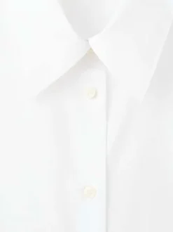 Chemisier blanc uni avec un col à revers et des manches longues