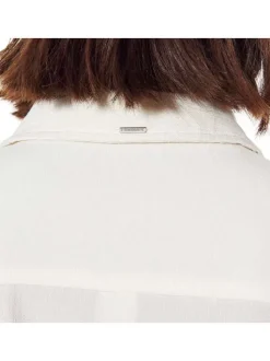 Chemisier blanc uni coupe droite avec un col américain et des franches smockées aux épaules et aux manches