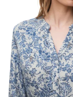 Chemisier bleu floral avec une coupe droite et un col tunisien