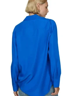 Chemisier bleu uni avec une coupe large un col français et à manches longues