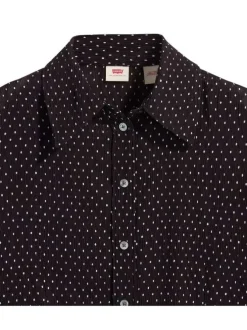 Chemisier noir transparent avec un imprimé à pois blancs et des manches longues