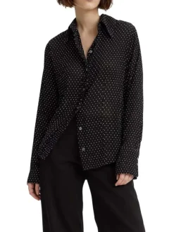 Chemisier noir transparent avec un imprimé à pois blancs et des manches longues