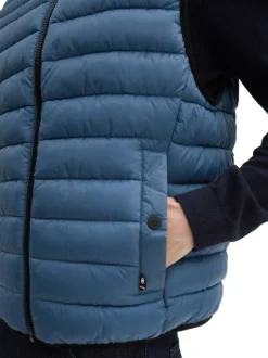 Doudoune sans manches bleue matelassée à col montant avec des poches à pression