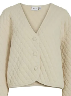 Gilet ecru uni matelassé avec une coupe droite et des manches longues