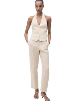 Gilet en lin beige clair uni dos nu fermé par des boutons à col v
