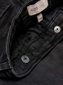 Jean noir en coton uni avec une coupe skinny et passants pour ceinture à la taille