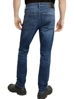 Jean en coton bleu avec des passants pour ceinture et une coupe slim