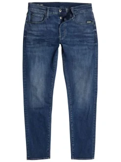 Jean en coton bleu avec des passants pour ceinture et une coupe slim