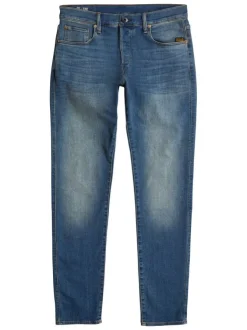 Jean en coton bleu avec une coupe slim et des passants pour ceinture