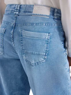 Jean en coton bleu denim pourvu d'une ceinture intégrée à nouer